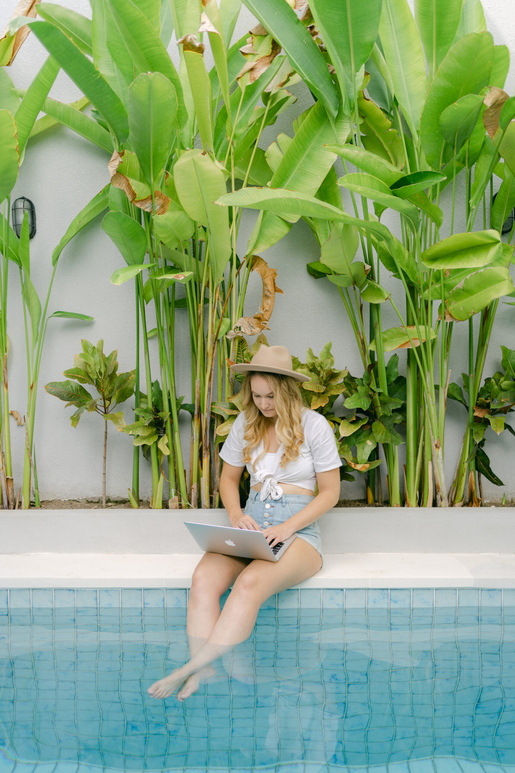 Social media manager reviewing pricing strategy on a laptop, preparing to inform clients about a price increase.