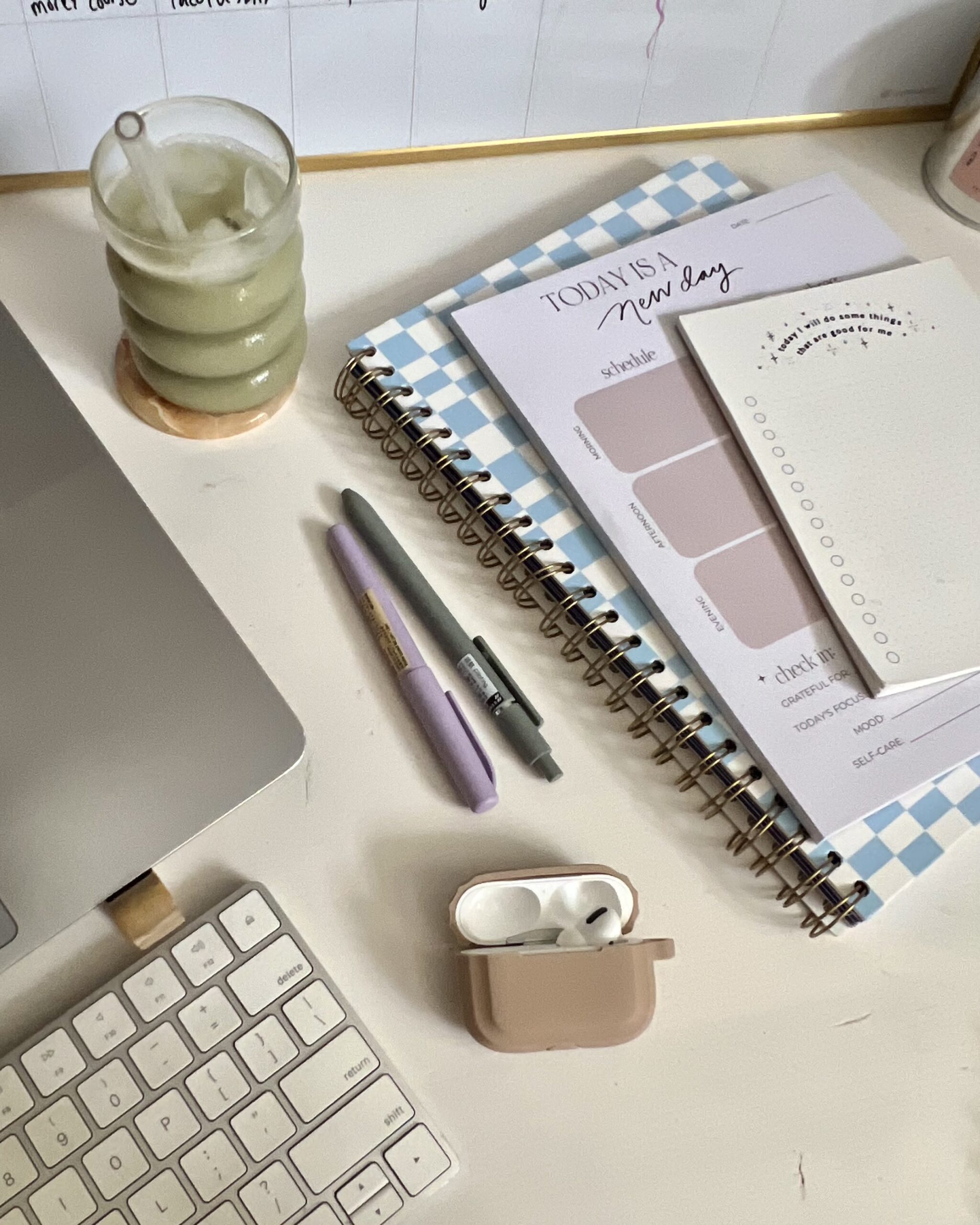 Flatlay of laptop and planner with personal brand strategy notes